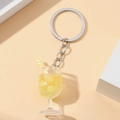 Detailed close-up of a luminous lemon drink keychain with a yellow striped straw - Yellow