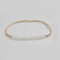 Macro detail of elastic beaded bracelet featuring natural white stones and gold accents - White Moonstone