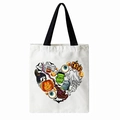 White Halloween canvas tote bag with black handles and a heart shaped spooky graphic - Heart Halloween Motifs