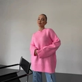 Oversize pink knit sweater with crew neck and ribbed cuffs shown on model - S / Pink