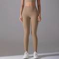 Detail of high-waisted seamless camel yoga pants showing high-stretch athletic fabric texture - Cocoa