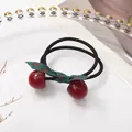 Elastic hair tie with red resin cherry charms and a green polka dot fabric bow knot - Dark Red Cherry Bow