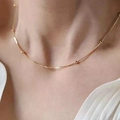 Elegant gold snake bone chain necklace with small beads worn on woman's collarbone - Single Layer Round Bead Snake Chain Necklace / Gold