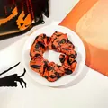 Halloween scrunchie in orange and black with spooky skull, bat, and castle prints - Orange Skull / Small Size