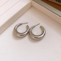 Detail of minimalist silver C-shaped thick hoop earrings with polished metallic mirror finish - Silver Thin C-Shape (3cm)