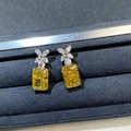 Macro shot of S925 silver studs with yellow radiant cut stone and floral crystal top - 925 Silver / Yellow
