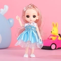 Pink haired doll in blue dress with white fur collar and silver accents on pink background - Loris Girl