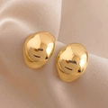 Detailed view of polished gold irregular pebble-shaped stud earrings on beige fabric - 8# Silver Earring Post - Irregular Smooth Oval