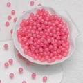 DIY handmade 6mm translucent pink glass round beads gathered in a white shell tray - Neon Pink Chalcedony Beads (6mm)