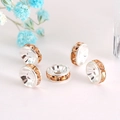Detailed macro view of five champagne crystal spacer beads for DIY jewelry making - Silver Plated Champagne
