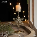 Golden snowflake candle holder for Christmas decor on a rustic wooden tray - Snowflake Style