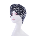 Detailed close-up of navy blue and white geometric print turban with spiral flower knot - Style 4-Navy White Geometric Spiral Knot