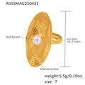 Macro detail of gold stainless steel ring with ripple texture and shell bead center - Gold / Size 7 (Adjustable)