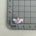 Detailed macro view showing the 1.5cm mini resin cartoon rabbit figurine size with ruler - White Dog with Pink Hat