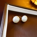 Elegant 10mm white freshwater pearl earrings with silver posts on brown jewelry box - Silver Pin Flat Pearl
