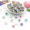DIY charm beads set with colorful enamel flowers and butterflies on a white ceramic plate - Enamel Large Hole Beads (15398) / Colorful (40g)