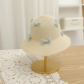 Detailed straw hat weaving with light blue lace bow on a decorative display stand - Beige Hat