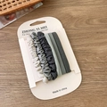 Set of 6 Morandi color hair scrunchies and ties in grey tones on a wooden surface - Grey Set