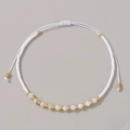 Handmade beaded bracelet with white shell beads and gold metal spacers on adjustable cord - White
