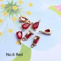 Detailed view of faceted red teardrop crystal pendants with gold plated metal base - 4*8mm / Red