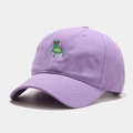Close-up of green frog embroidery detail on a lavender cotton baseball cap fabric - Purple