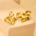 Detailed view of elegant gold bow stud earrings on a textured stone display base - Gold Bowknot Stud Earrings