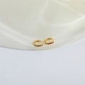Minimalist gold hoop earrings with small red zircon stones on elegant white silk fabric - Rose Red