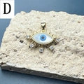 Macro detail of gold evil eye pendant with blue shell inlay and sparkling crystals - D-Ray Eye
