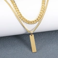 Macro shot of gold double-layered necklace with cuban links and rectangular bar pendant - Rectangle Pendant Style / Gold