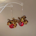 Dettaglio dell'orecchino a fiore leopardato ambra con perla rossa e gancio dorato - Gancio per Orecchio Fiore Leopardato con Perla Rossa