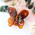 Elegant amber butterfly hair claw clip with transparent hollow design in medium size - Jelly Amber Red