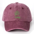 Detail of burgundy washed cotton baseball cap with green clover and Lucky embroidery - One Size / Burgundy