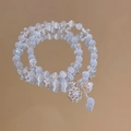 Elegant beaded bracelet with light blue cat eye stones and a floral charm pendant - White-Cat Eye-Flower
