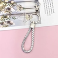Detailed close-up of a silver braided leather keychain with metal lobster clasp and ring - Silver