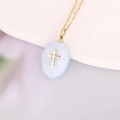 Detailed macro view of a light blue teardrop pendant with golden cross on a gold chain - Light Blue Oval Cross (2#)
