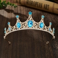 Detailed shot of golden crown with blue and clear rhinestones on vintage book - Gold Base Lake Blue Zirconia