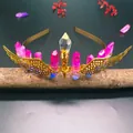 Detailed shot of handmade gold wings bridal headband with colorful raw crystal stones - Purple Blue + Gold Wings