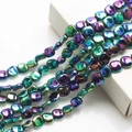Macro shot of 12mm rhombus iridescent plated glass beads for DIY jewelry making - Purple Green AB