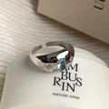 Adjustable silver ring featuring a light blue oval zircon and side crystal accents - Oval Light Blue Gemstone Open Ring (J3959)