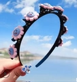 Kids flower braided headband with pink and blue smiley face charms in black plastic finish - Pink Smiley Face