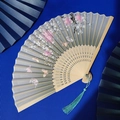 Bamboo folding fan with silk cherry blossom pattern and elegant cyan tassel accent - Cyan Cherry Blossom Butterfly