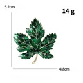 Detailed macro view of the green enamel maple leaf brooch with crystal studs and gold edges - Maple Leaf / Green