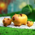 Three capybara figurines in different sizes on green grass for car dashboard decor - Three Little Capybaras Set (HX-059)