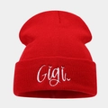 Close-up of red knitted beanie featuring detailed white Gigi embroidery on the folded cuff - One Size / Red