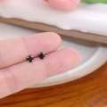 Minimalist black round zircon stud earrings with silver four-prong setting on a finger - Vertical Prong No.4 / Black