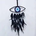 Detail of handmade evil eye dreamcatcher with black feathers and woven blue core - Single Layer Black Evil Eye