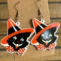 Close-up of Halloween black cat earrings with orange wizard hat on display card - Style 3