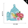 Embroidered birdcage patch with a yellow bird and pink flowers, size 4.6cm by 4.8cm - Blue Birdcage with Bird