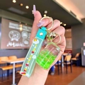 Luminous flowing liquid keychain with green sand and astronaut bottle held in hand - Green Luminous Bubble Bead Coke Can