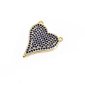Macro shot of heart-shaped gold pendant with micro-pave blue cubic zirconia stones - Blue